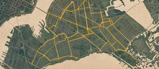 Aerial map of the Brooklyn street grid with its connected network of protected bike lanes traced in gold