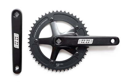 State Bicycle Black Label v3 48T fixed-gear crankset in black — top-down view showing 144 BCD chainring and crank arms with white logo