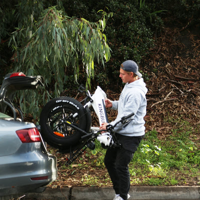 A man folds the Literider Ebike and puts it in the trunk
