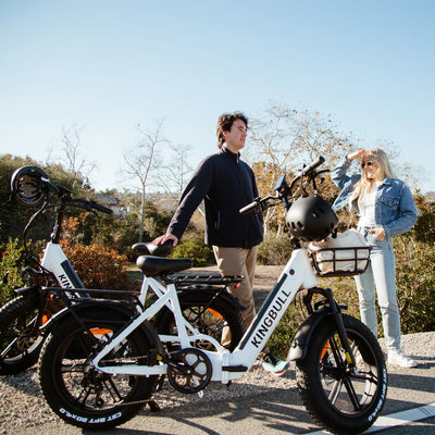 Two people standing next to the folding electric bike Literider